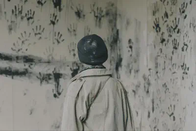 Person Looking at Room with Handprints