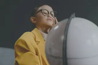 Child Looking at Globe