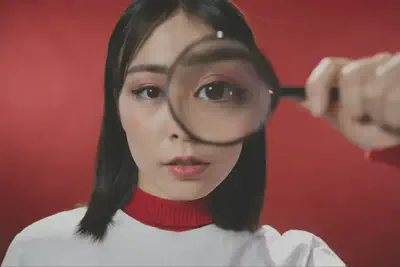 Girl Looking Through Magnifying Glass