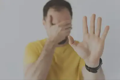 Man Covering Face with Hand Out