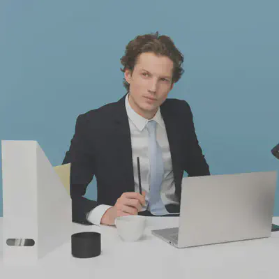 Man Sitting in Front of Desk