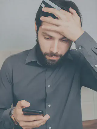 Stressed Man Looking at Smartphone