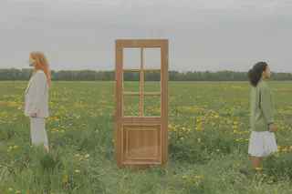 People in Field Back to Back with Door