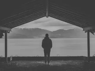 Person Standing in Front of Lake
