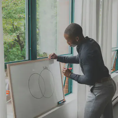 Person Drawing on Whiteboard