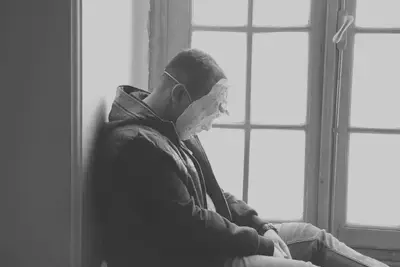 Man Wearing Mask Near Window