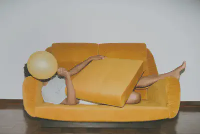 Person Layong on Orange Sofa