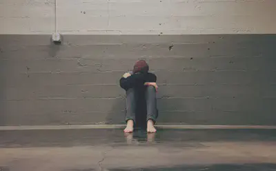 Person Leaning on Wall