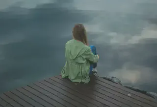 Woman Sitting on Dock