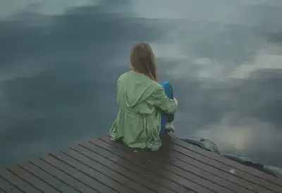 Woman Sitting on Dock