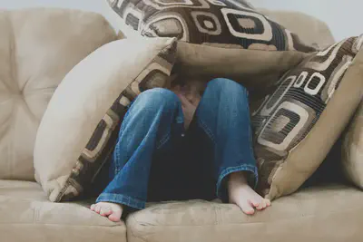 Kid Hiding in Pillows