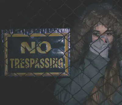 Woman Beside No Trespassing Sign