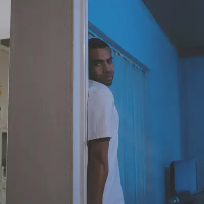 Man Hiding Behind Wall